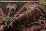Hand-knotted distressed Oushak pile texture, vibrant pink, charcoal, beige, and teal.