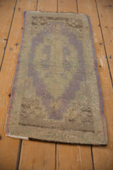 Upper corner of the distressed Oushak rug mat, highlighting worn texture and intact side cord.