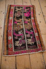 Textured side selvage of vintage distressed Oushak rug with pink and rust geometric border.