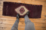 Distressed vintage Oushak rug runner, deep aubergine field, ivory stepped medallion, weaver inscription.