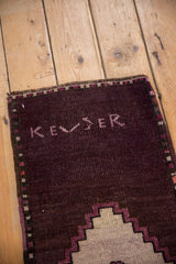 Vintage Distressed Oushak rug, 'KEZER' weaver inscription, aubergine, mauve geometric border.