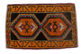 Distressed vintage Oushak rug with gold, saffron, and charcoal geometric medallions.