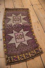 Vintage distressed Oushak runner, mauve starburst medallion with speckled aubergine field and abrash.