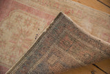 Distressed vintage Oushak rug's blush and beige pile with visible hand-knotted reverse.