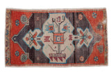 Vintage distressed Oushak rug mat with central tree-of-life medallion in rust, charcoal, and beige.