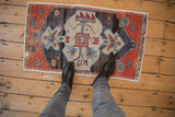 Distressed Oushak rug displaying beige tree-of-life medallion and rust-toned spandrels.