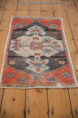 Distressed vintage Oushak rug mat, angled view showcasing its muted rust and charcoal medallion.