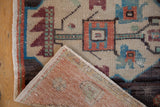 Distressed Oushak rug pile showing beige, rust geometric motifs and woven foundation.