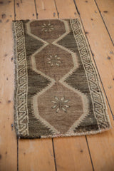 Vintage Distressed Oushak rug mat features budded blossom motif and low pile.