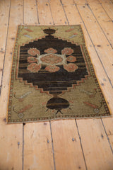 Distressed Oushak rug, central stepped medallion with dusty rose primitive floral motifs.