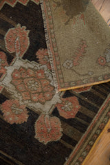 Vintage Oushak rug's distressed pile showing dusty rose florals and its woven reverse.