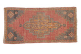 Distressed vintage Oushak runner with a stepped medallion, coral abrashed ground, and dark gray spandrels.