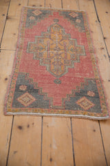 Distressed Oushak rug corner with stepped contour spandrel, coral abrash, and worn knot heads.