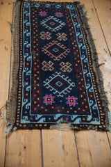Anatolian rug mat with tattered ends, geometric guls in pink, beige, and charcoal.