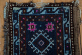 Worn side edge of a vintage Mafrash Anatolian rug, revealing foundation, dark blue, brown, pink patterns.
