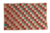 Distressed Oushak rug mat with checker pattern in faded red, seafoam green, and ivory.