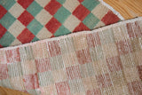 Distressed Oushak rug: faded red, seafoam green, ivory checker pile and hand knotted reverse.