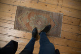 Distressed vintage Oushak rug pile shows even wear, sandalwood and pale seafoam tones.