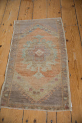 Distressed Oushak rug pile with visible knot heads in muted sandalwood, pale slate, and seafoam green.