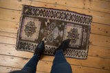 Distressed vintage Kars rug mat with geometric pattern, short pile, and bronze, ivory, mauve colors.