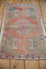 Vintage distressed Anatolian rug detail with stepped medallion, germinating plant, abrashed pale rose field, and even wear.