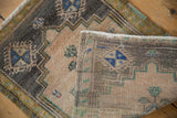Distressed Oushak rug's muted pile texture, hand knotted foundation, and side cord selvage.