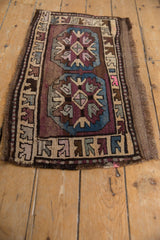 Mafrash style Kars rug detail: plum and blue geometric medallion, arrowed motifs, even wear.