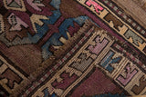 Distressed Kars rug mat texture with geometric arrowed patterns in plum, pale blue, and beige.