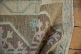 Distressed texture of the Kars rug, highlighting decorative pink and seafoam green.
