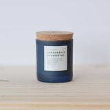 Lemongrass and Tangerine Soy Candle in a frosted dark blue glass jar with cork lid.
