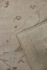 Distressed Oushak carpet pile showing even wear, faded patterns, and its woven foundation.