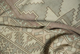 Distressed Oushak rug, showing texture and geometric pawn and serrated leaf motifs.