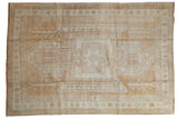Vintage distressed Oushak rug, oversized Sewan Kazak medallion, central pomegranate starburst, gold, ivory.