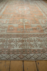 Distressed Oushak rug border detail with geometric patterns, pale terracotta, ivory, and visible distress.