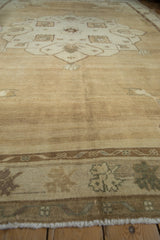 Distressed vintage Oushak rug texture, showing heavily abrashed field and muted neutral tones.