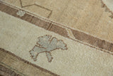 Vintage Distressed Oushak rug's woven texture and stylized ram's horn motif in earth tones.