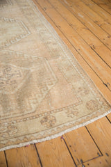 Distressed surface texture with soft beige and ivory color variations on this Oushak runner.
