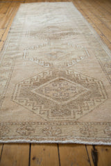 Vintage distressed Oushak runner texture shows mostly even wear and muted beige geometric motifs.