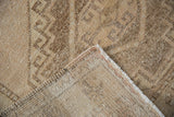 Distressed Oushak runner corner revealing textured neutral pile and hand-knotted foundation.