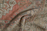 Distressed Oushak rug detail, showing faint foundation and muted dusty rose patterns.