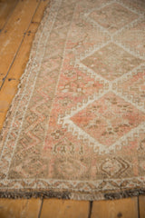 Softened pile and detailed diamond columns with hook motifs on a vintage Oushak rug.