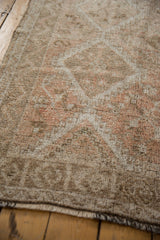 Distressed vintage Oushak rug runner, showing worn beige pile, subtle motifs, and short fringe.
