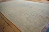 Worn, low-pile texture and visible knot heads on a distressed vintage Oushak carpet.