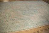 Textured, low pile of a distressed Oushak rug with visible knot heads and wear.