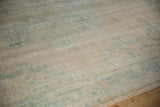 Detailed texture of the distressed vintage Oushak showing visible knot heads and a low, even pile.