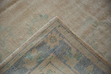 Detail of the hand-knotted foundation and distressed pile on a vintage Turkish Oushak corner.