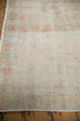Worn pile texture of vintage distressed Oushak rug, showing visible foundation, faded blush, powder blue.