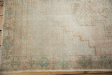 Distressed Oushak rug section highlighting exposed foundation and subtle geometric patterns.