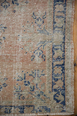 Corner view showing distressed wear to the knot heads on a vintage hand-knotted Oushak rug.