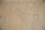 Sandy beige hand-knotted pile of a distressed Oushak rug showing characteristic even wear.